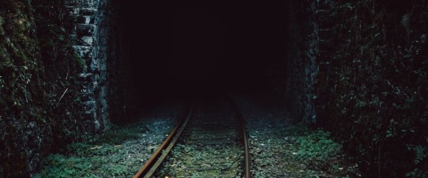Image of the entrance into a dark tunnel